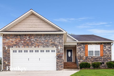 a brick house with a white garage door