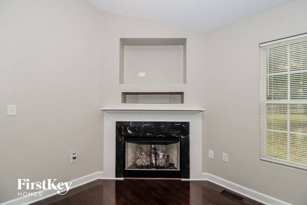 a living room with a fireplace and a window