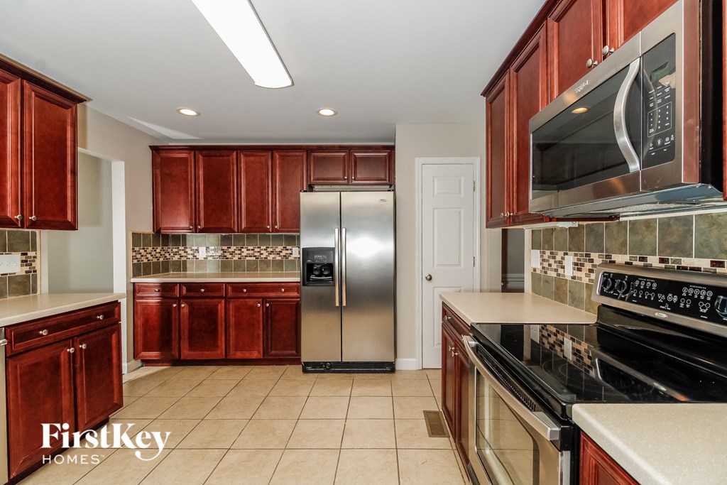 a kitchen with wooden cabinets and stainless steel appliances