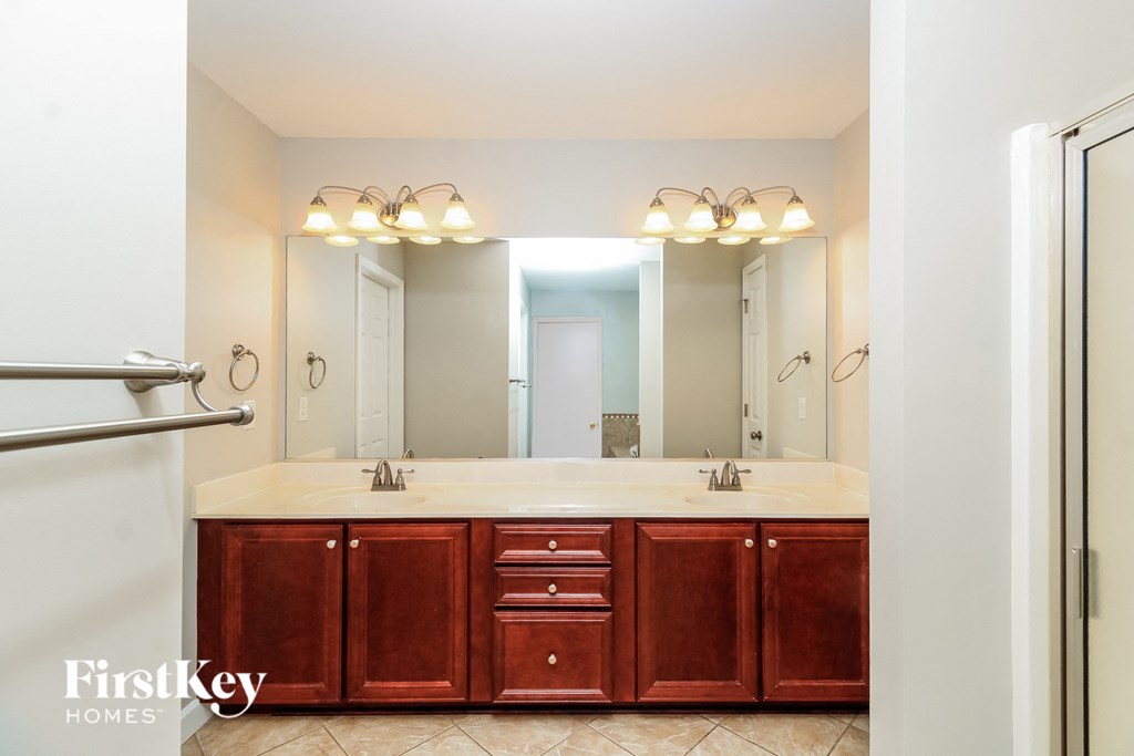 a bathroom with two sinks and a large mirror