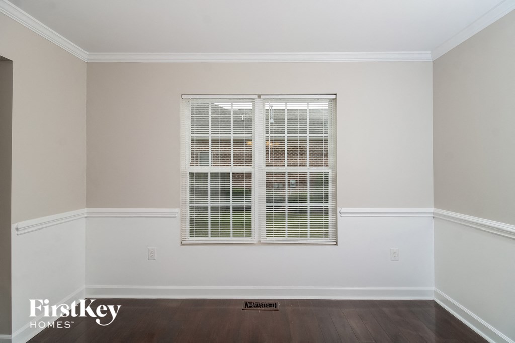 a window in a room with white walls and wooden floors