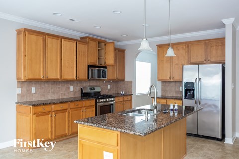 A kitchen with wooden cabinets and granite countertops.