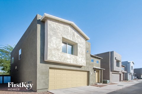 a house with a garage door in front of it