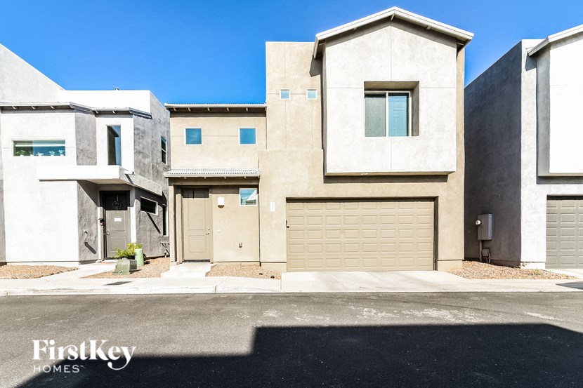 a beige and tan house with two garage doors