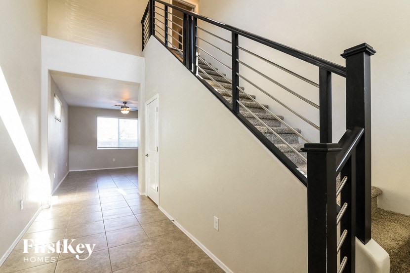 the landing of the staircase into the living room and dining room