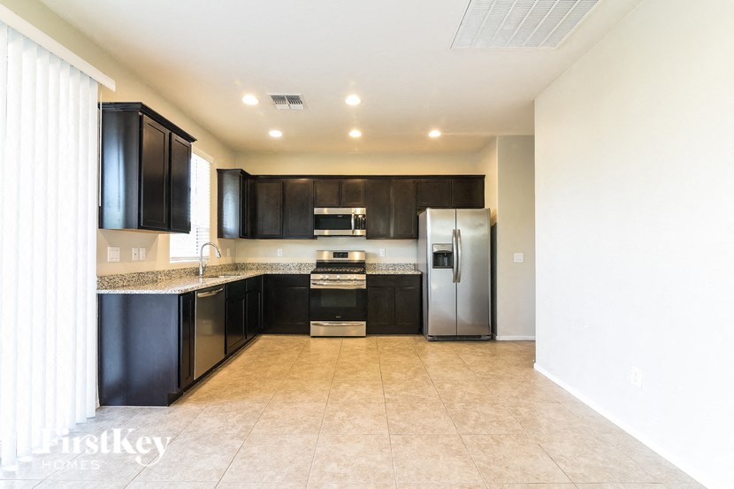 a modern kitchen with black cabinets and stainless steel appliances