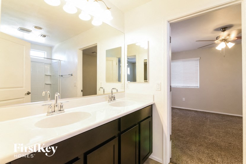 a bathroom with two sinks and a large mirror