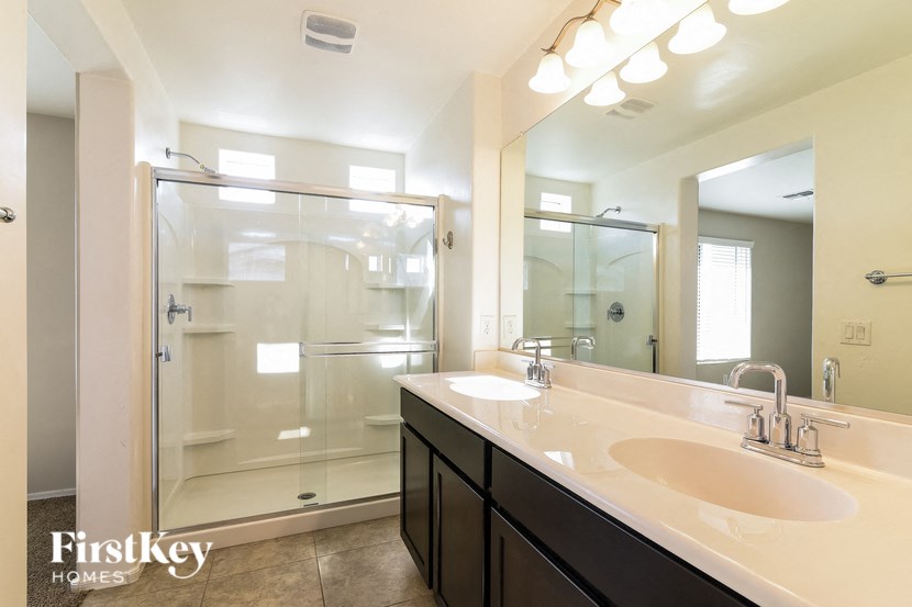 a large bathroom with two sinks and a shower