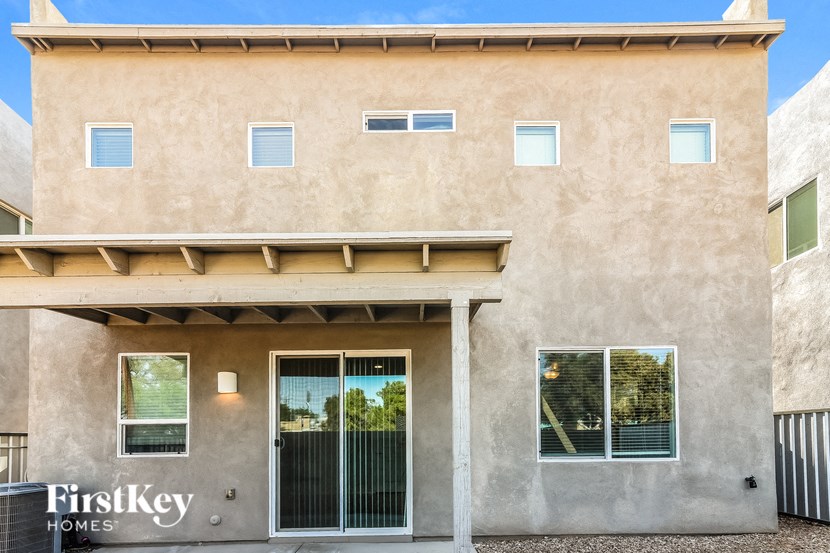 the front of a building with a door and a garage door