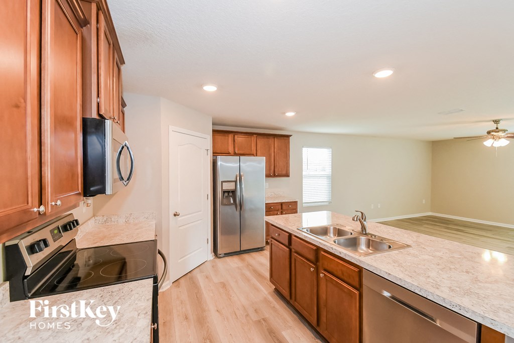 a kitchen with wooden cabinets and stainless steel appliances