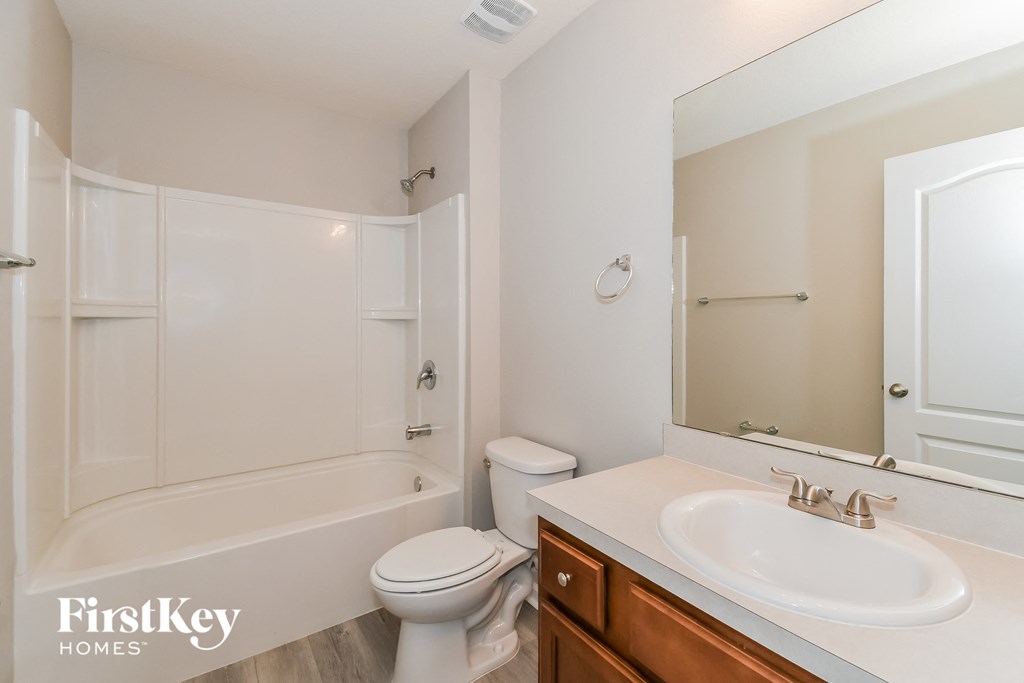 a bathroom with a sink and a toilet and a bath tub