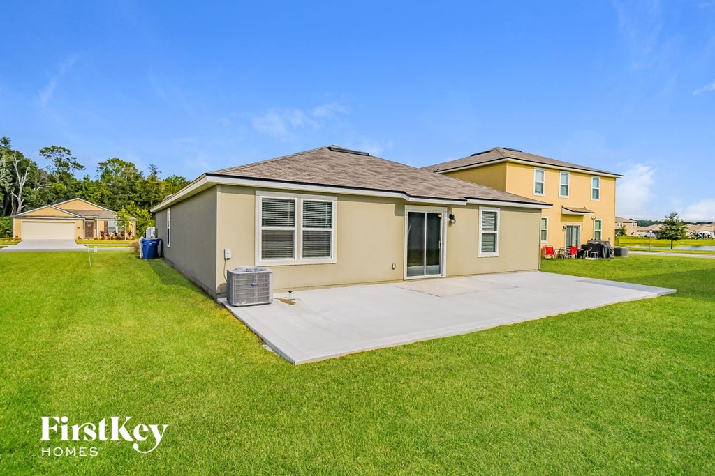 a home with a driveway and a yard with grass