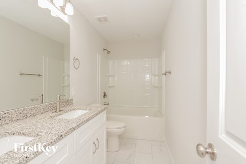 a bathroom with a sink and a toilet and a shower