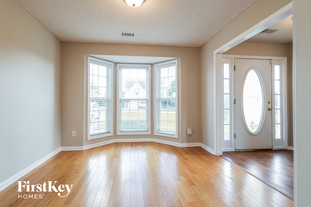 A room with wooden floors and a white door.