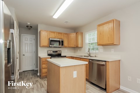 A kitchen with wooden cabinets and a white countertop.