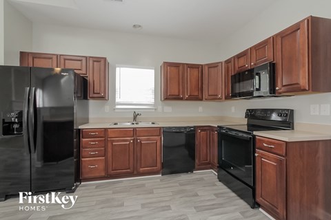 a kitchen with wooden cabinets and black appliances