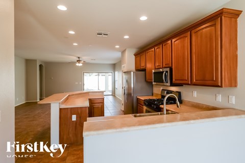 A kitchen with wooden cabinets and a refrigerator.
