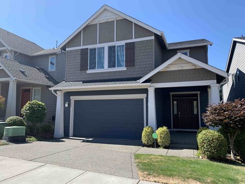 a house with a garage door in front of it