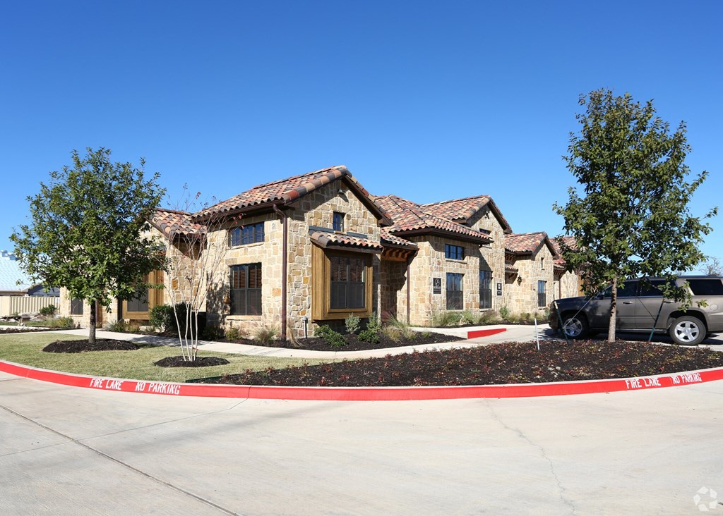 a house with a car parked in a parking lot