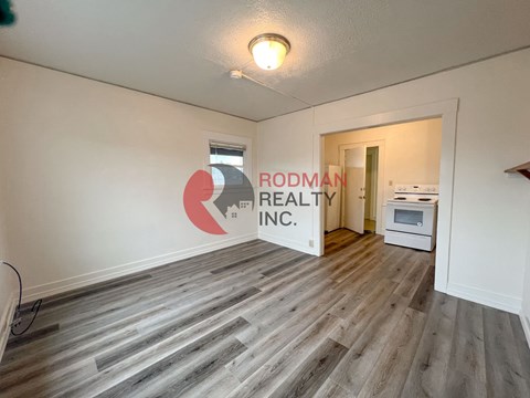 A room with Rodman Realty Inc. logo on the wall.