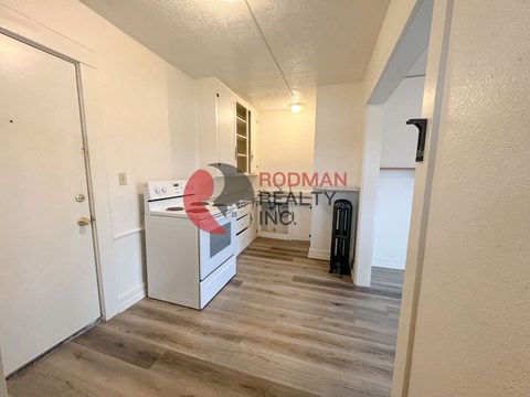 A room with a white door and a sign that says "RODMAN REALTY INC."