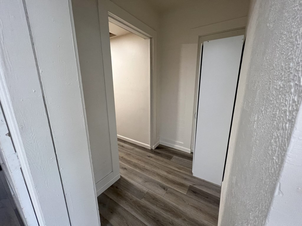 a bedroom with a closet and a hallway with two doors