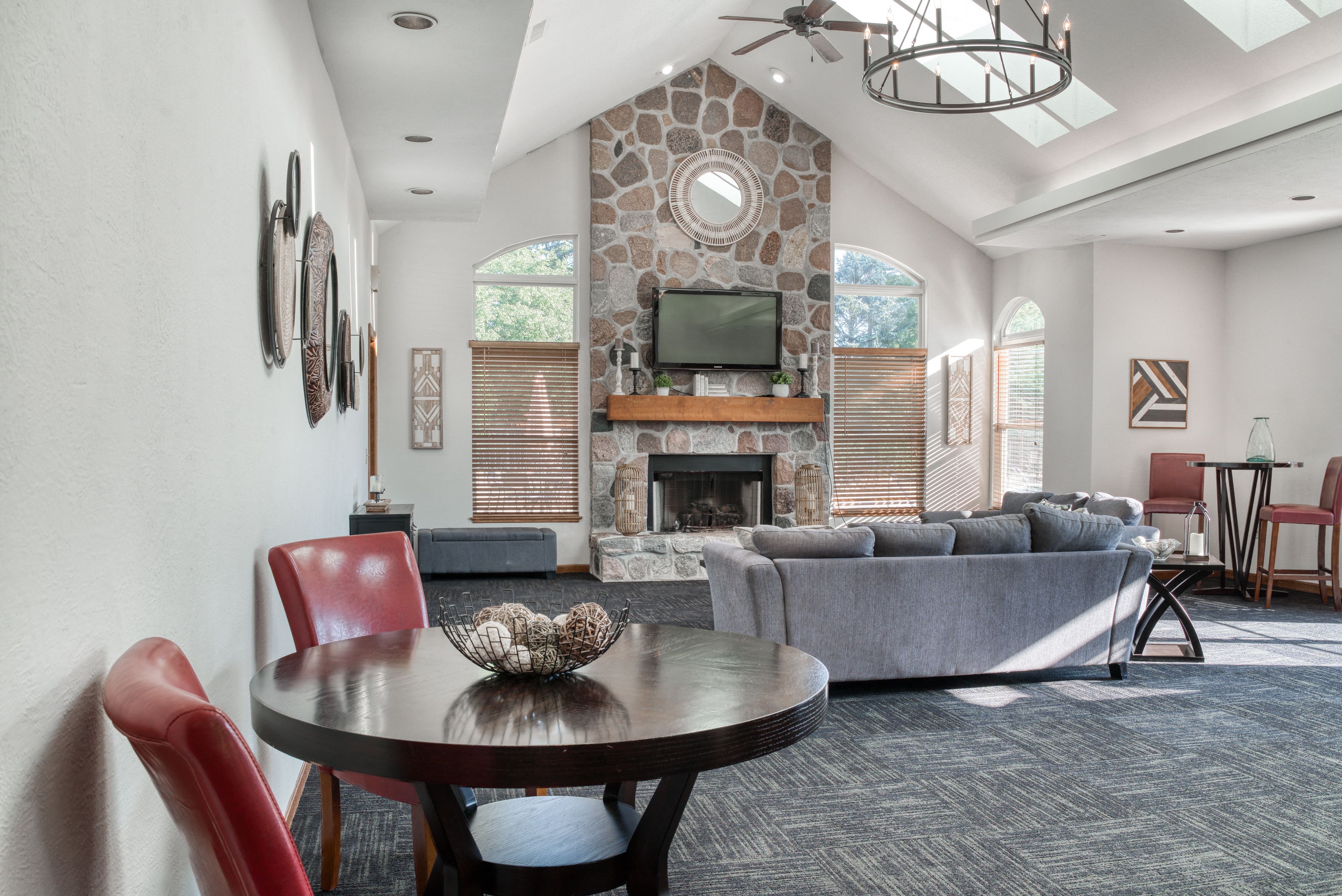 a living room with a couch and a table and a fireplace