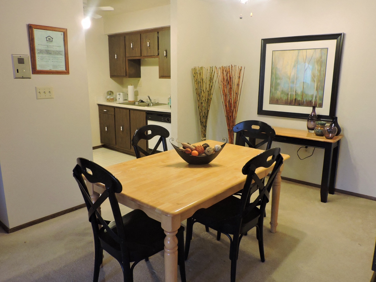 a dining room with a wooden table and chairs