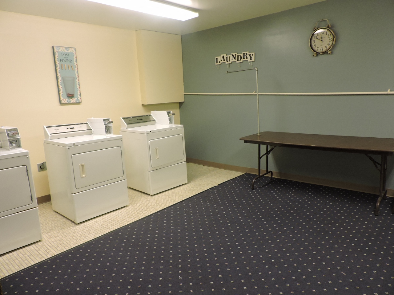 a laundry room with washing machines and a table
