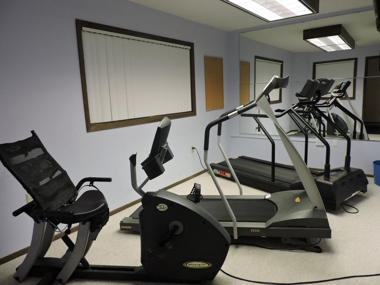 a gym with a row of exercise machines