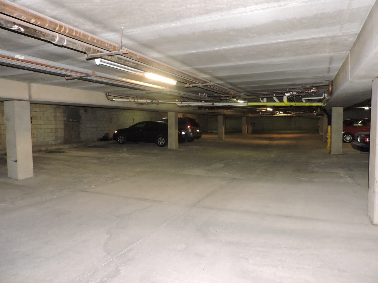 a parking garage with a car parked in it