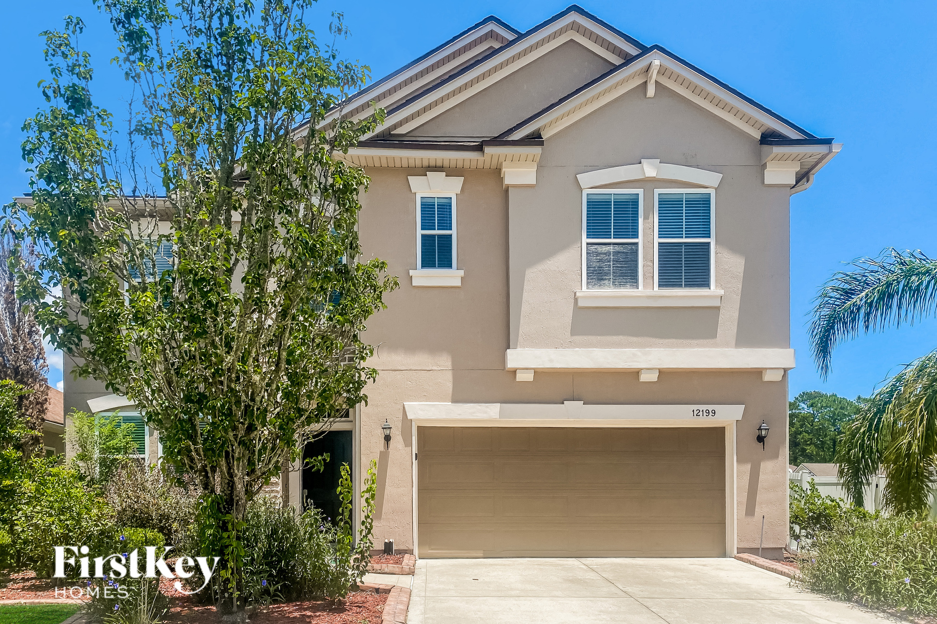 a beige house with a garage door in front of it