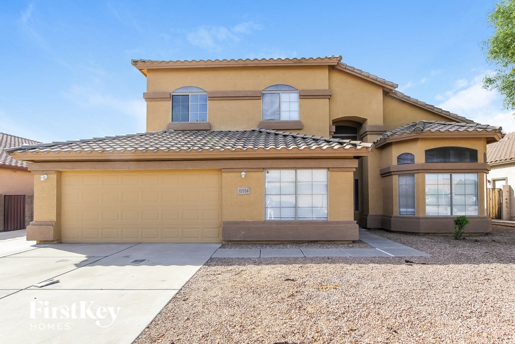 a yellow house with a sidewalk in front of it