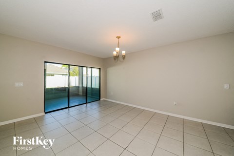 an empty living room with a sliding glass door to a patio