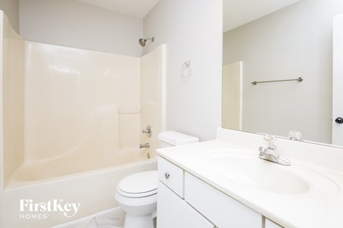 a white bathroom with a sink and a toilet