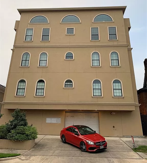 a red car parked in front of a building
