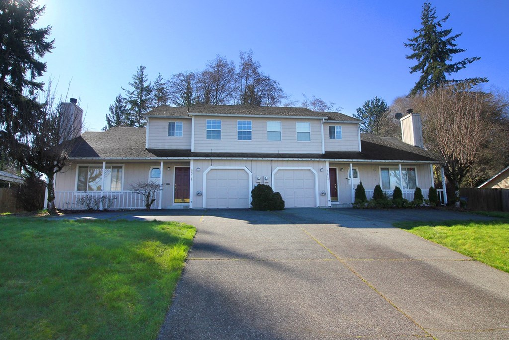 a large white house with a driveway in front of it