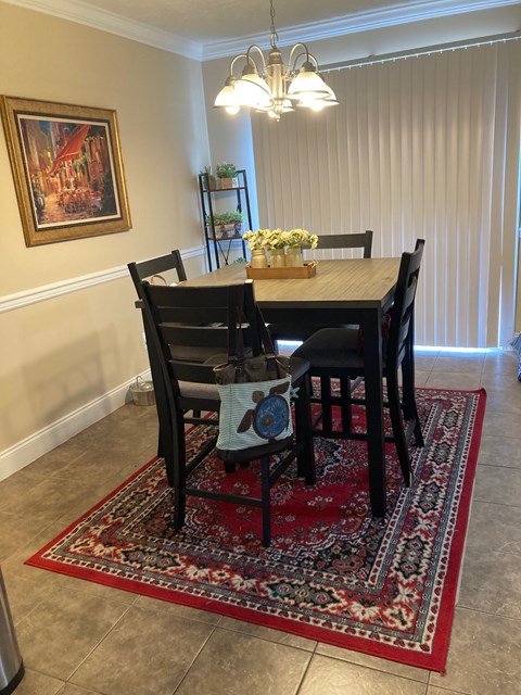 A dining room with a table set for four.