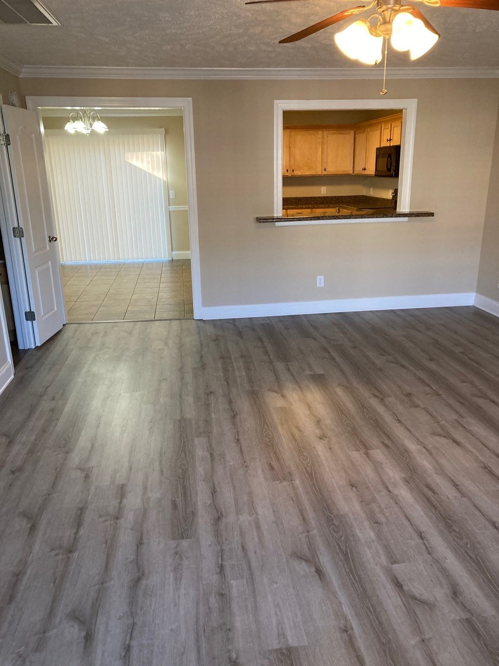 an empty living room with a wood floor
