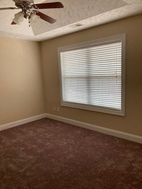 a living room with a window and a ceiling fan