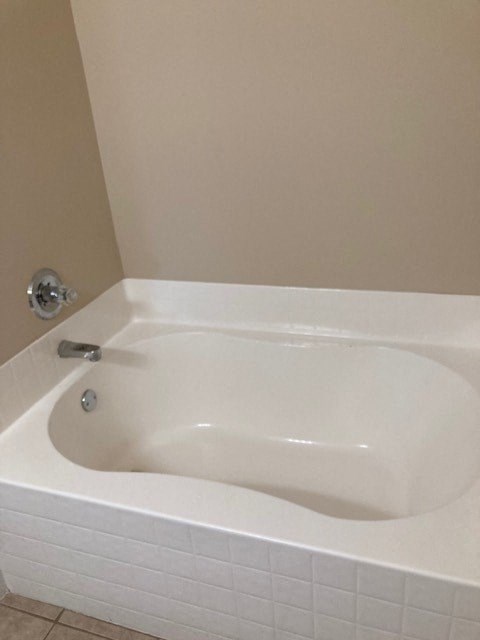 a white bath tub in a bathroom with a sink