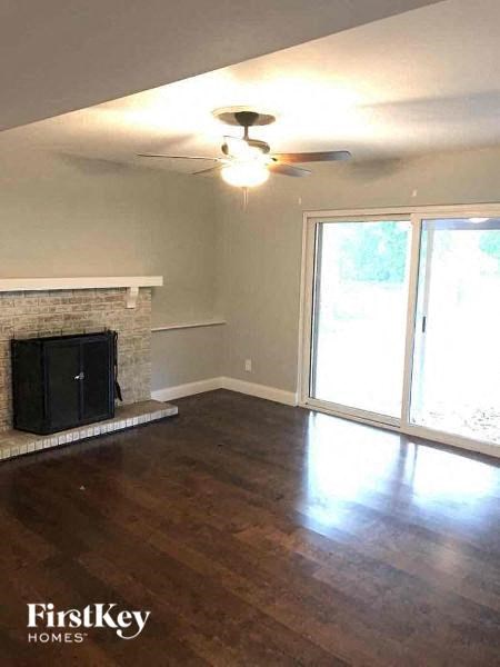 A room with a fireplace and sliding glass doors.