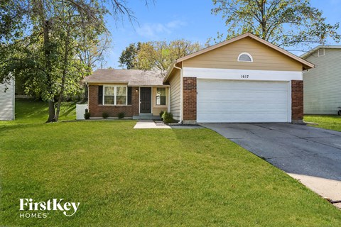a home with a driveway and a lawn
