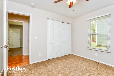 a bedroom with a closet and a door to a hallway