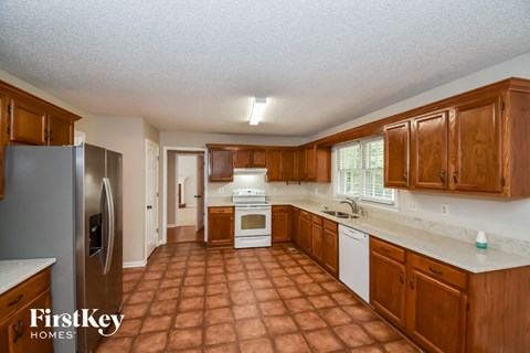 a kitchen with wooden cabinets and a sink and a refrigerator