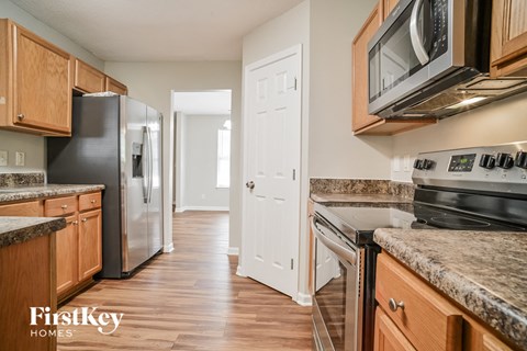 a kitchen with wooden cabinets and stainless steel appliances