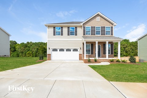 a house with a white garage door in front of a lawn