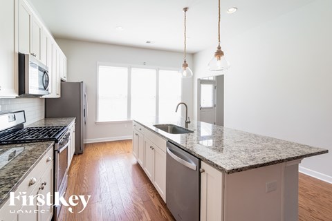 A kitchen with granite countertops and stainless steel appliances.