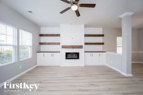 A spacious living room with a fireplace and wooden accents.