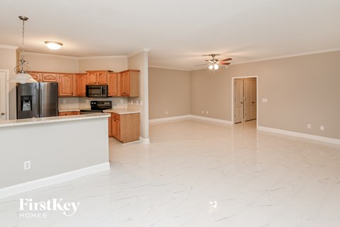A kitchen with wooden cabinets and a refrigerator.